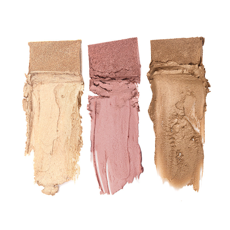 Three swatches from the Shopgalaxys Classic Beach Glow Palette are smeared on a white background. From left to right, they feature light beige, dusty rose, and warm brown shades with a matte texture. Each is crafted using Hot-Pour Technology for smooth application with visible brush strokes.