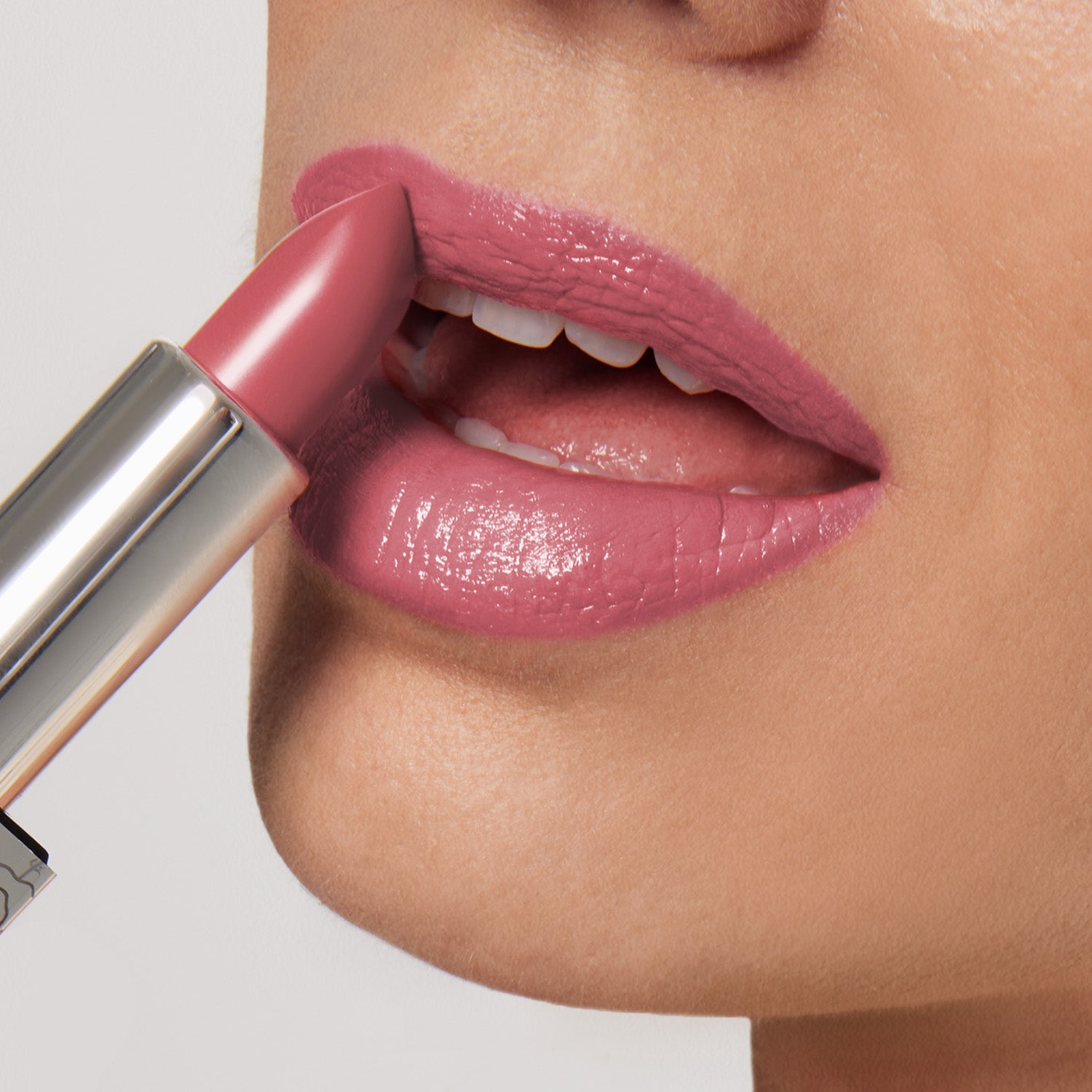 A person applies Shopgalaxyss Actually, I Can Shiny Velvet Cream Lipstick #33. The ultra-creamy pink hue highlights the parted lips, showcasing the glossy, hydrating texture against a neutral background.