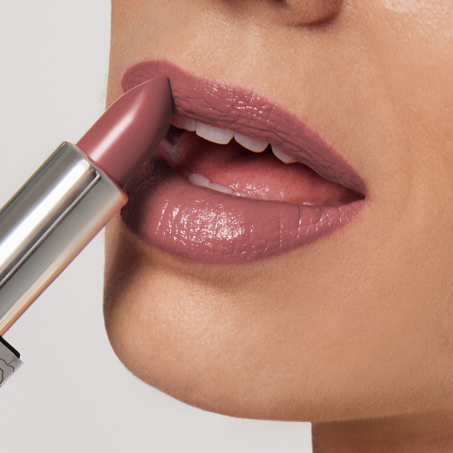 Close-up of someone applying Shopgalaxyss Aperitif Shiny Velvet Cream Lipstick #419, highlighting its smooth, glossy finish and hydrating, cruelty-free formula; a perfect match for mature lips against a soft, neutral background.
