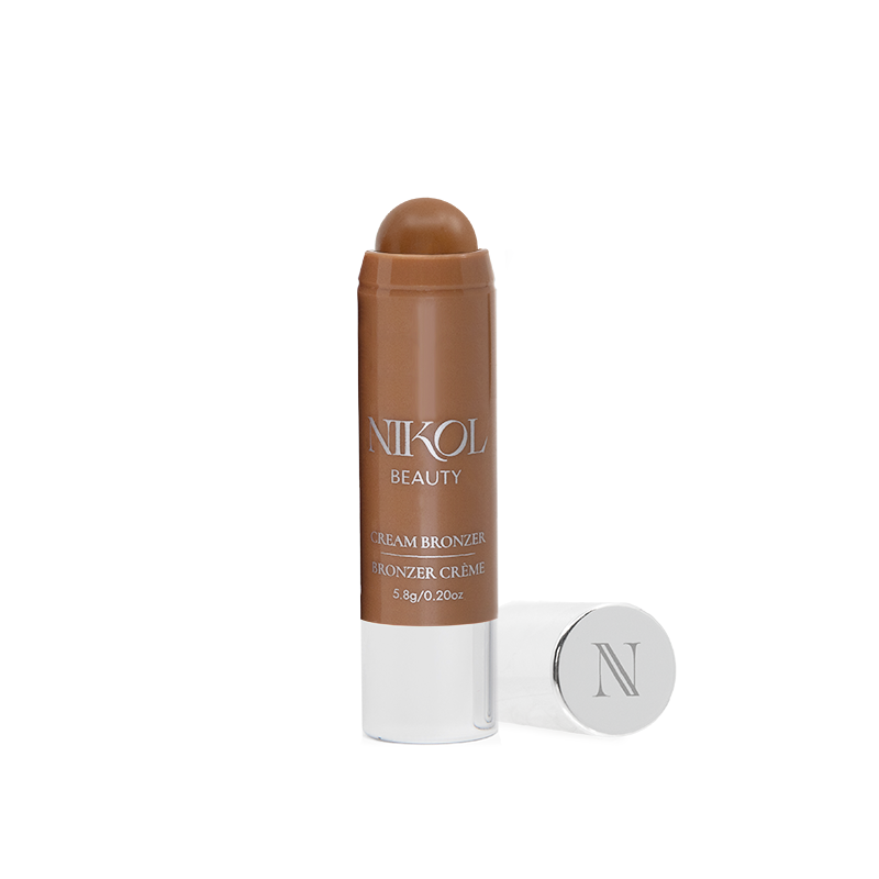 A Cream Blush Stick by Shopgalaxys stands upright, cap off to show the rich brown shade. Next to it is a silver cap with an N. Ideal for mature beauty fans, this versatile stick suits any look against a white background.