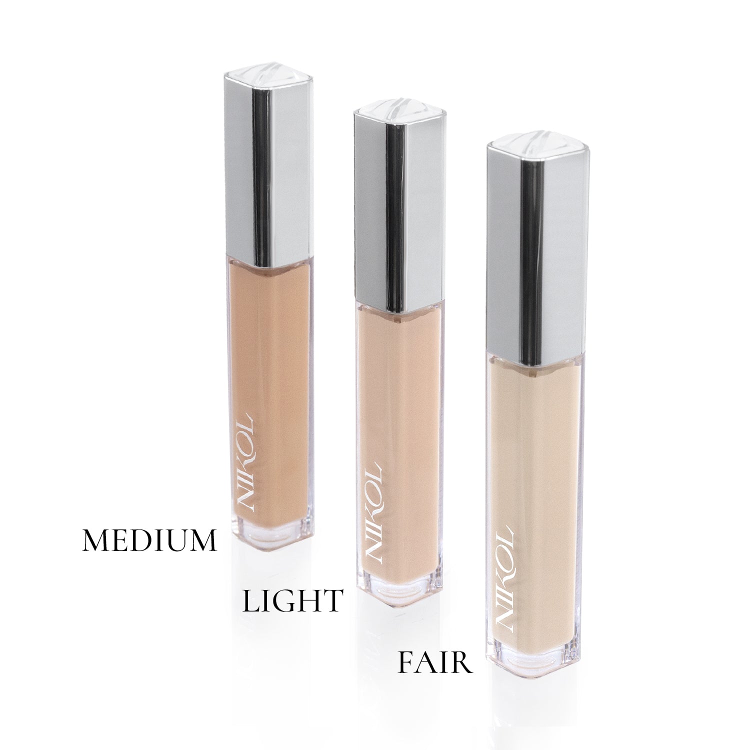 Three bottles of liquid foundation, labeled Medium, Light, and Fair, are arranged vertically against a white background. Each has a silver cap and clear body displaying various shades. Enhance your look with Shopgalaxyss Creamy Concealer for flawless coverage that embodies Clean Beauty.