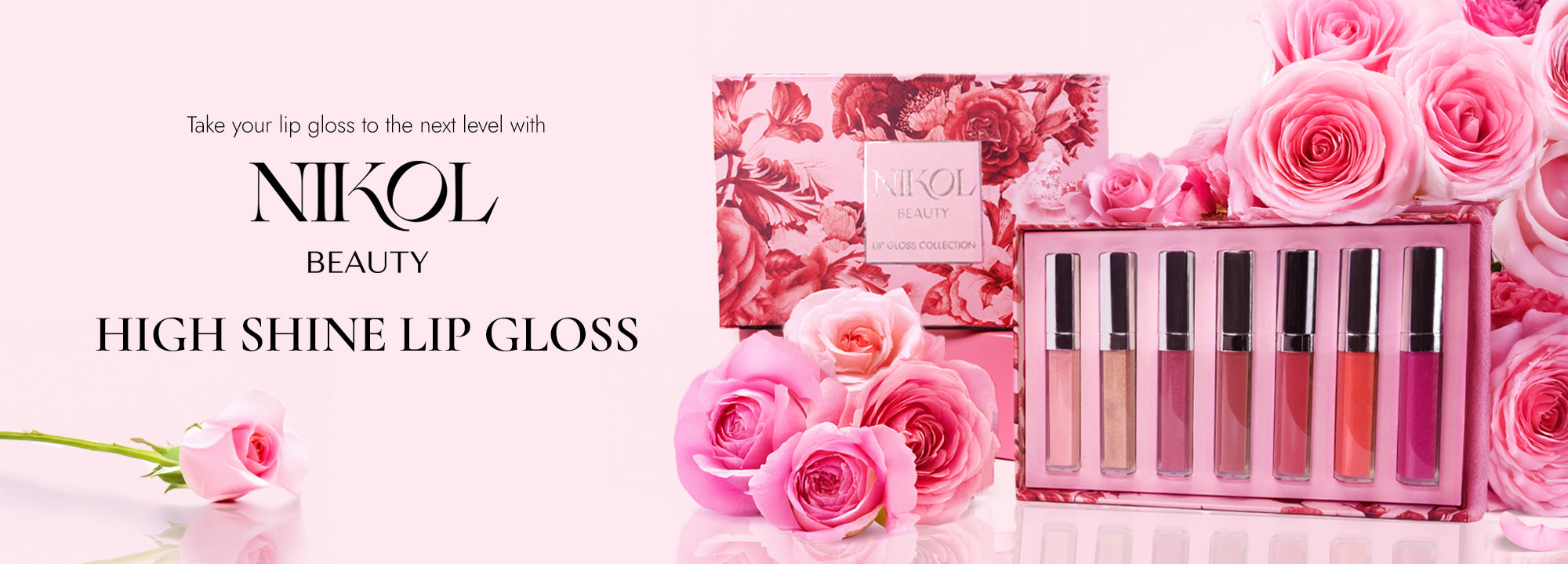 A display of Shopgalaxys High Shine Lip Gloss set with six lip gloss tubes in a pink floral box, surrounded by pink roses on a light pink background. Text promotes taking lip gloss to the next level.