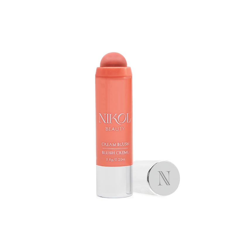 The Coral Cream Blush Stick from Shopgalaxys is ideal for mature routines. This creamy bronzer has a rounded tip and upright design, with a silver cap beside it. The sleek tube elegantly features the product name and weight details.