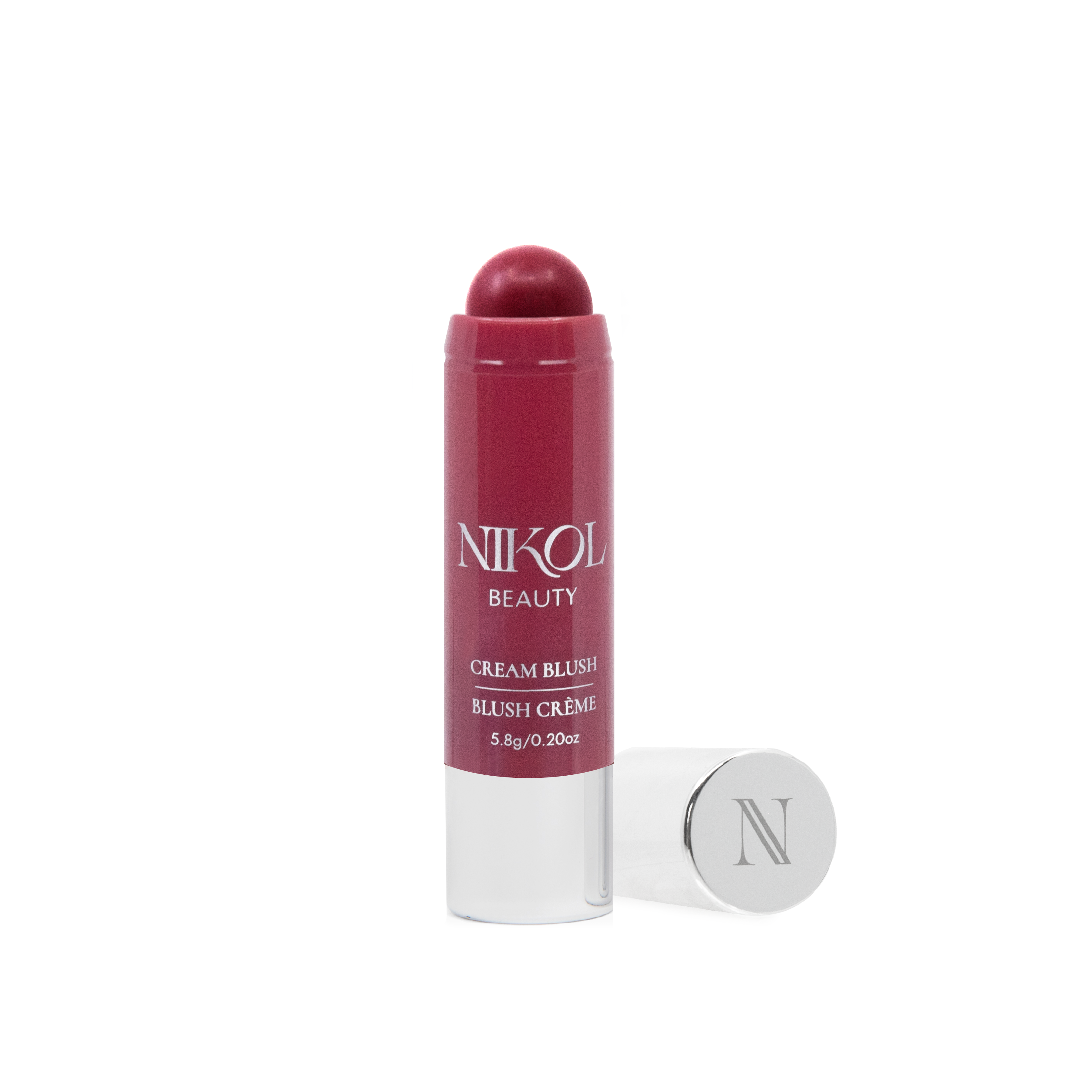 The red Cream Blush Stick from Shopgalaxys, perfect for mature skin, features a shiny silver cap beside it. The open blush displays the creamy bronzer texture with a stylized N on the cap.