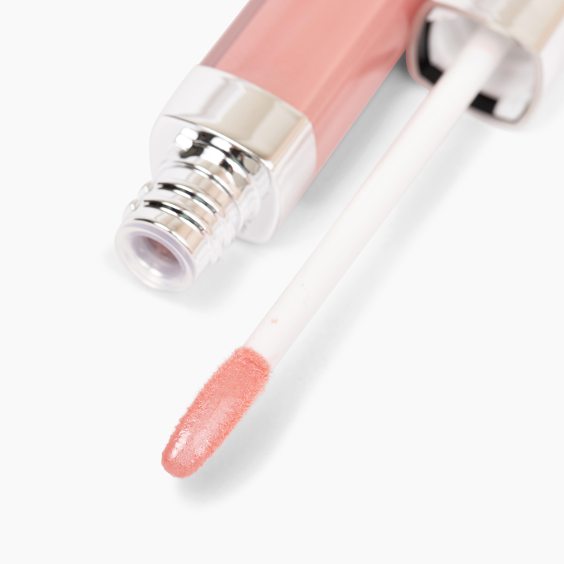 Close-up of Champs Lip Gloss #461 by Shopgalaxys, featuring a non-sticky formula in a soft pink shade for high-impact shine. The tube has a metallic cap, and the white applicator wand is coated in pink gloss.