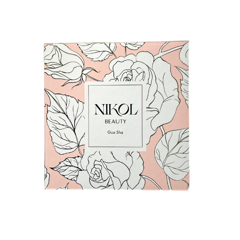 A square box with a pink background and white floral designs centers on a white rectangle displaying Gua Sha Stainless Steel by Shopgalaxys, emphasizing its lymphatic drainage benefits.